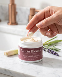 Fingertip scooping Lemongrass & Lavender tallow cream from the jar