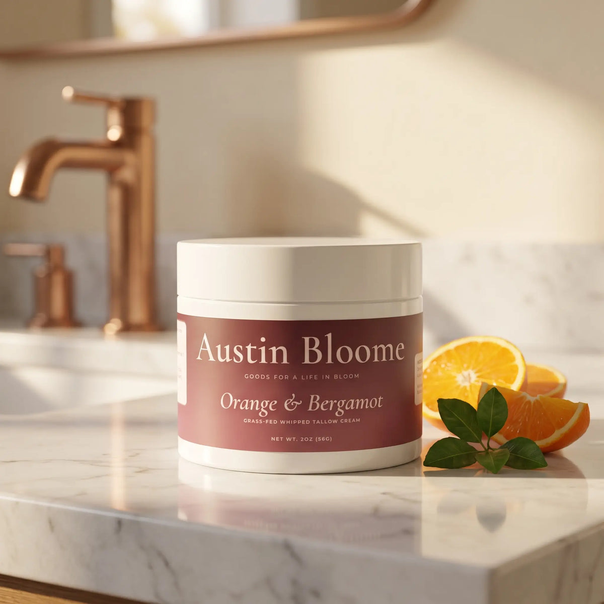 Tallow Cream Orange & Bergamot jar on a white marble bathroom benchtop with copper tapware