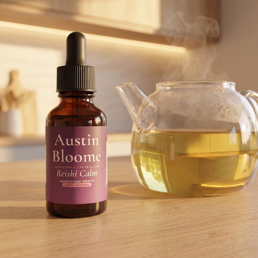 Reishi Calm Drops on a warm evening kitchen bench beside a glass teapot of herbal tea