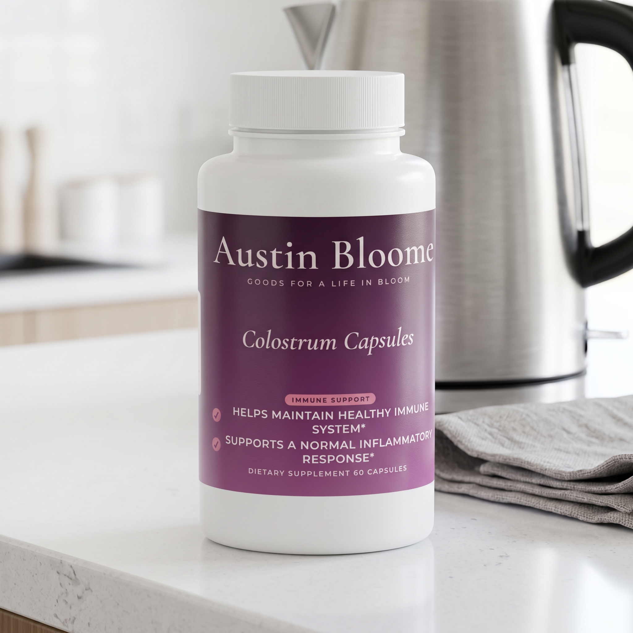 Colostrum Capsules on a bright white kitchen counter beside a kettle