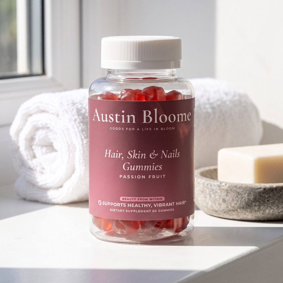 Hair, Skin & Nails Gummies on a sunlit bathroom window ledge with a rolled towel