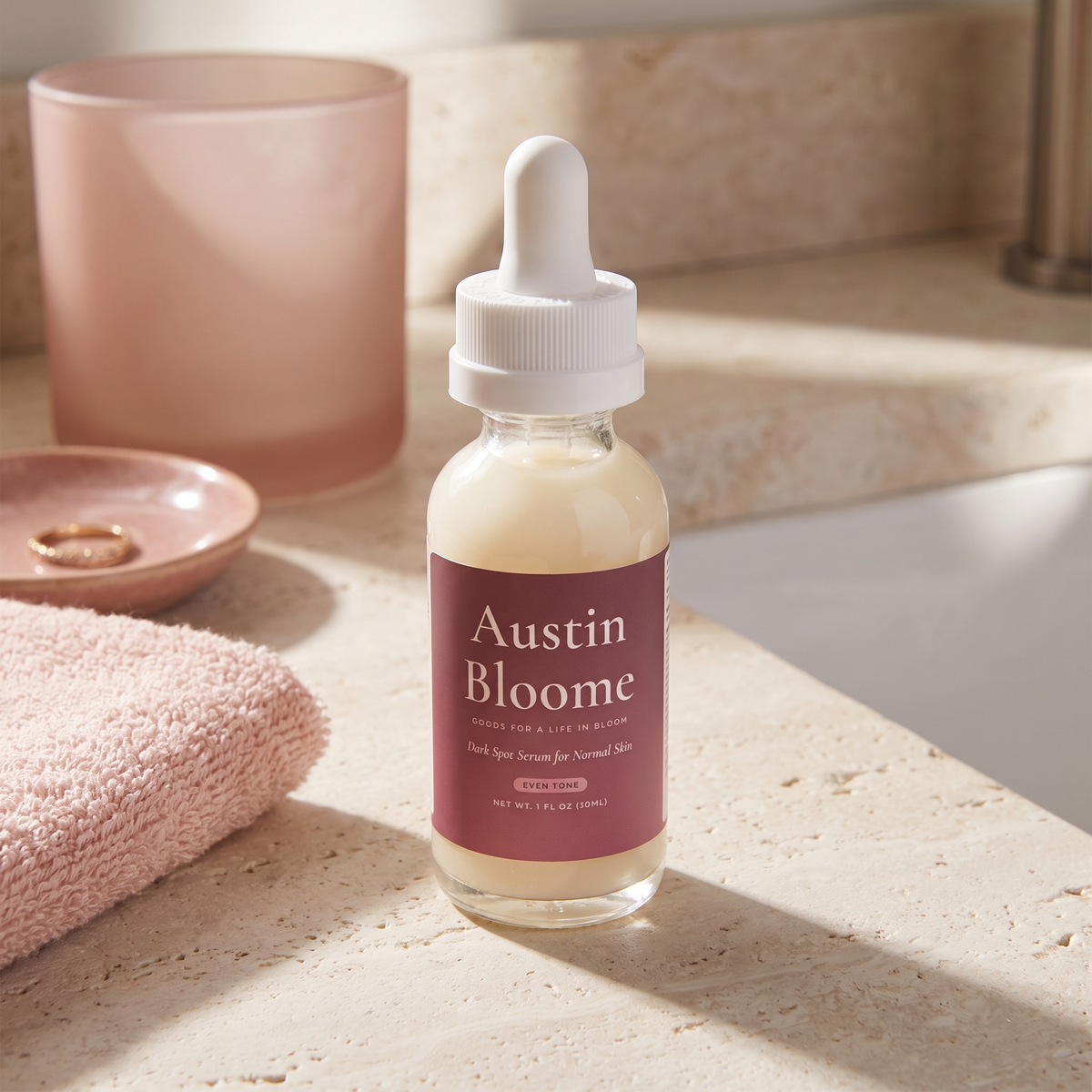 Dark Spot Serum on a sunlit limestone bathroom counter with a blush towel