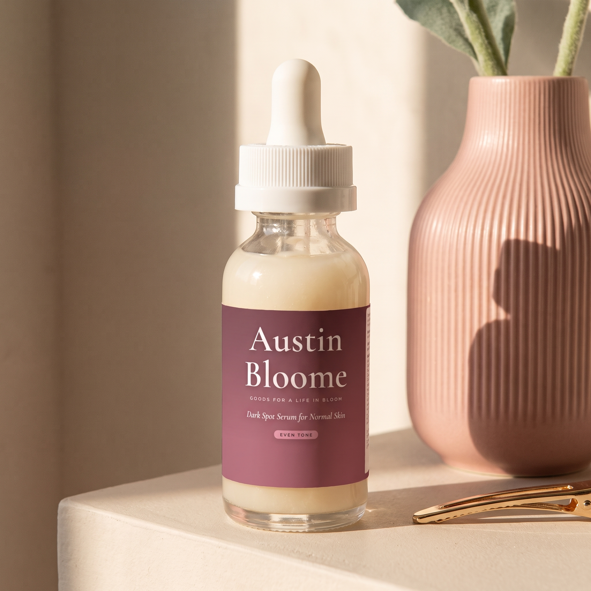 Dark Spot Serum on a plaster ledge in a stripe of afternoon light beside a rose vase