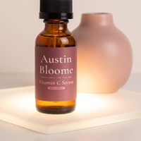 Vitamin C Serum glowing on a lit frosted glass panel